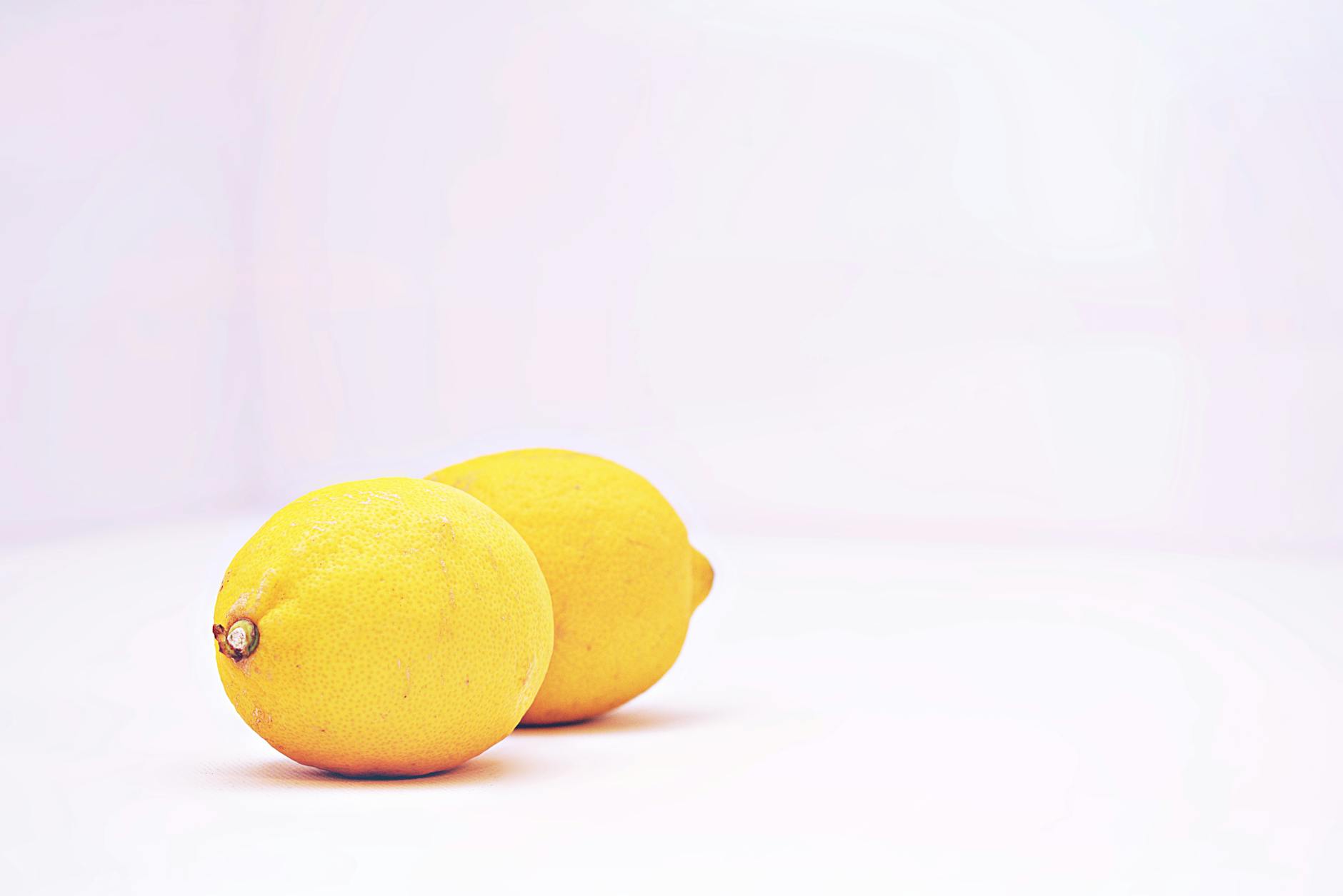 Fresh lemons on a white background representing fresh approaches to intimate exploration