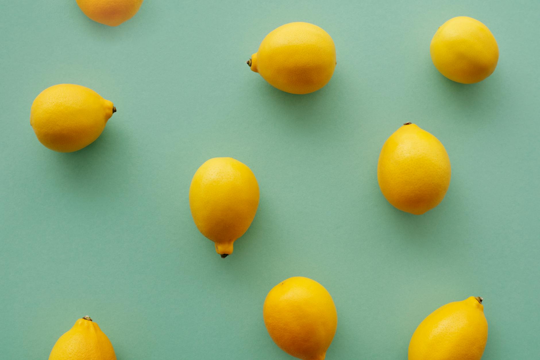 Bright yellow lemons on a soft pastel background, symbolizing renewal and gentle awakening of the senses.